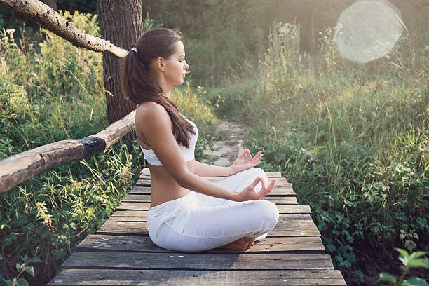 istock Meditating in green surrounding 618523568