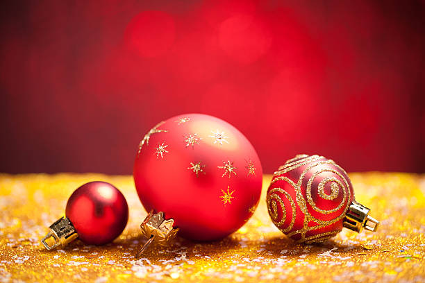istock Christmas baubles on gold glitter with red background 618525108
