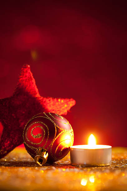 istock Candle and baubles on glitter with red background 618525962