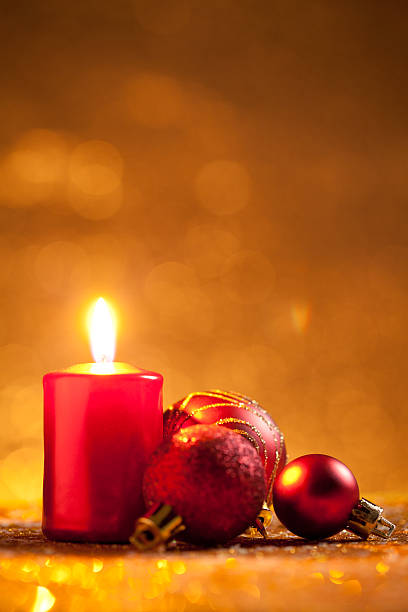istock Candle and baubles on glitter with gold background 618526154
