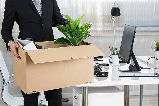 midsection of businessman carrying cardboard box - firing unemployment downsizing box imagens e fotografias de stock