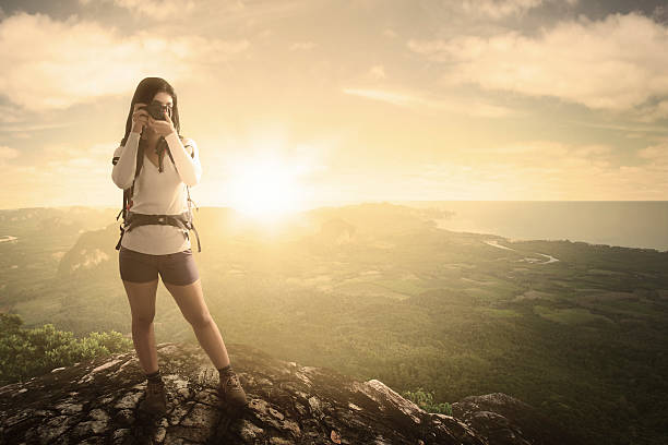 istock Female hiker and camera with valley view 618527074
