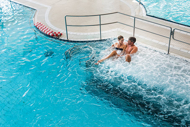 istock Couple in thermal wellness spa on water massage 618527290