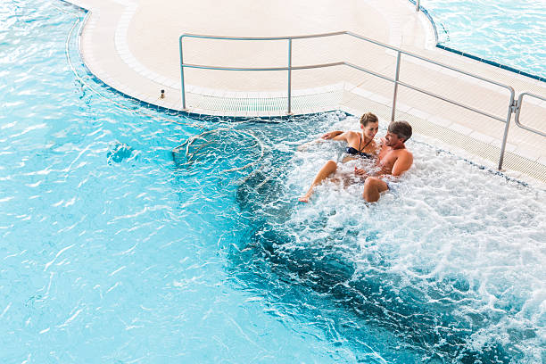 istock Couple in thermal wellness spa on water massage 618527526
