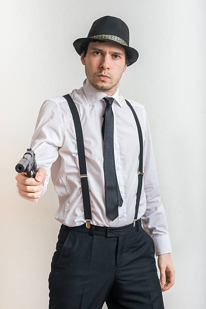 istock Young detective is aiming with gun with silencer. 618527646