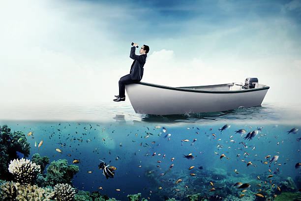 istock Businessman with binoculars on boat 618527842
