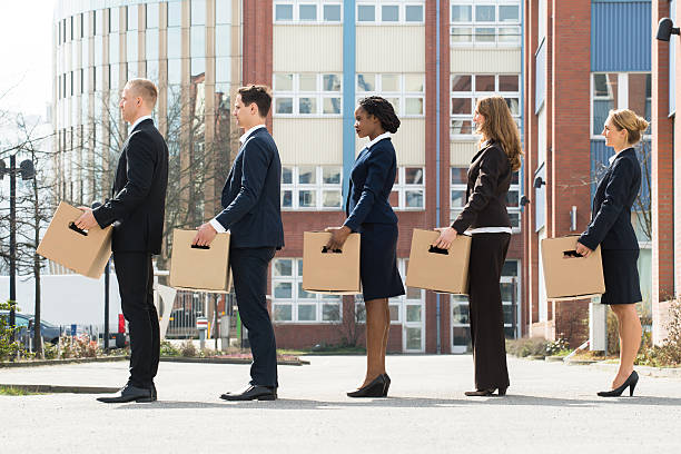 businesspeople with boxes standing in a line - firing unemployment downsizing box imagens e fotografias de stock