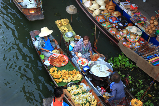 Ratchaburi, Thailand- February 13, 2011:Local people sell food items at Damnoen Saduak floating market .