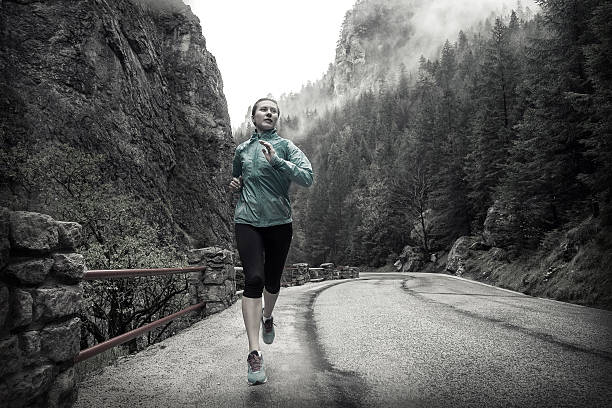 istock Running on the road around mountains under snowly rain. 618530696