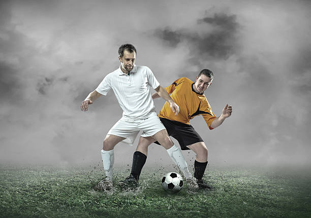 istock Football player with ball in action under sky with clouds 618530860
