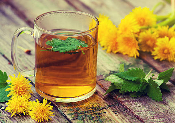 istock The cup of melissa herbal tea on a wooden table 618532312