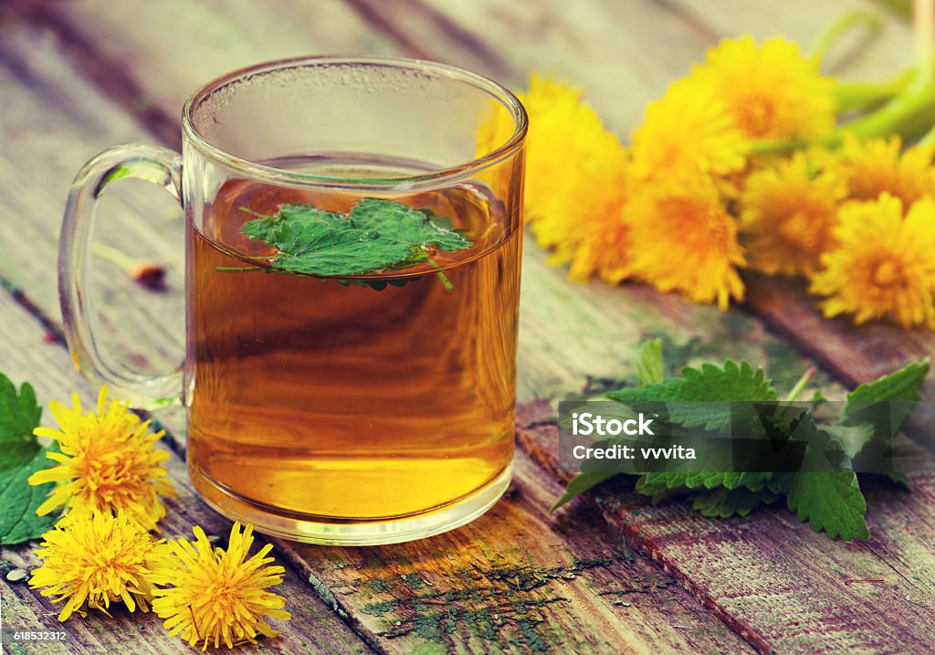 The cup of melissa herbal tea on a wooden table Alternative Therapy Stock Photo