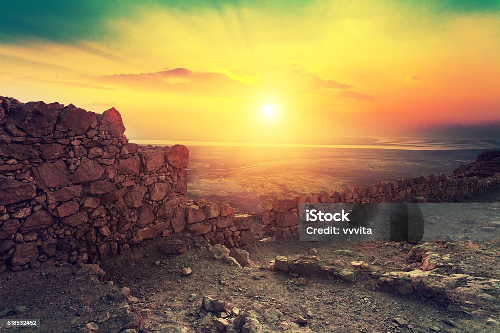 Beautiful sunrise over Masada fortress Beautiful sunrise over Masada fortress. Ruins of King Herod's palace in Judaean Desert. Israel Stock Photo