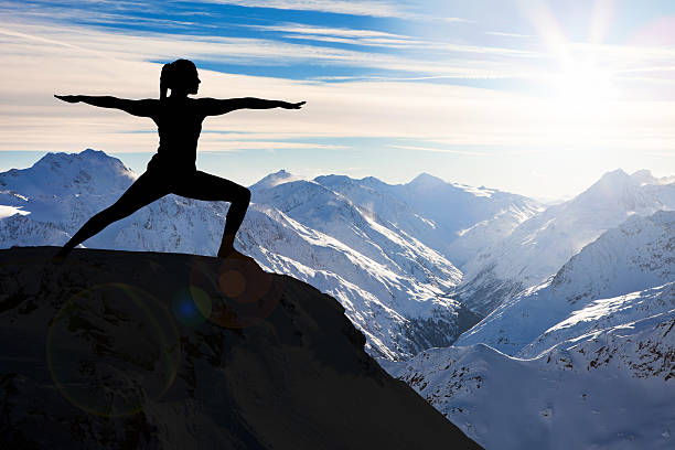 istock Woman Practicing Yoga On A Cliff 618532750