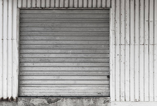 istock Metal warehouse wall with closed gate 618533614
