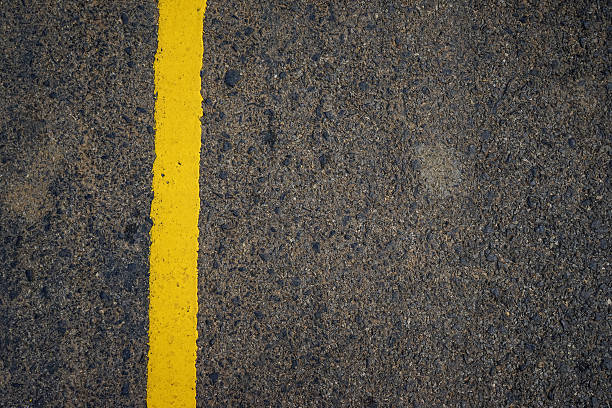 istock yellow line on the road texture 618535118