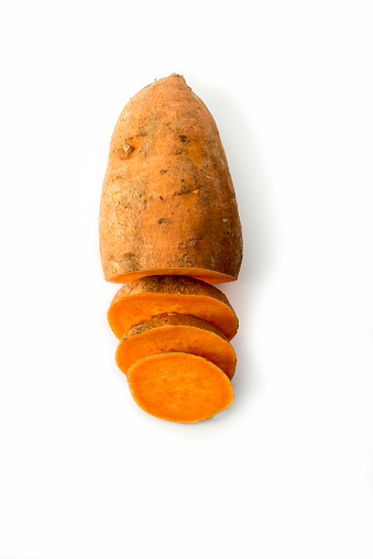 High angle view of one sweet potato, half sliced up.