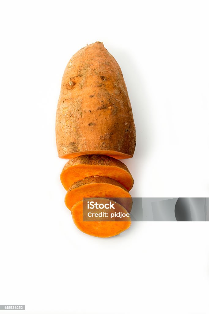 Sweet potato isolated on white studio background High angle view of one sweet potato, half sliced up. Sweet Potato Stock Photo