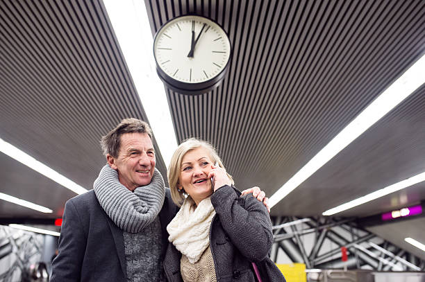 istock Senior couple standing at the underground platform, calling 618536424