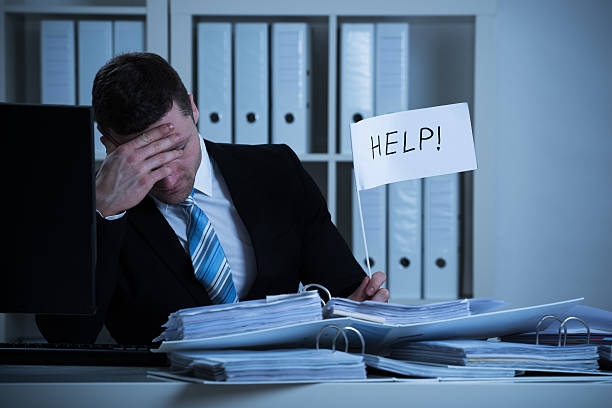 istock Stressed Accountant Holding Help Sign At Desk 618536592