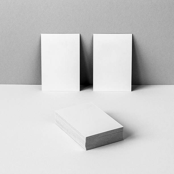 Blank business cards Vertical blank business cards with stack in front of them mockup square business card mockup stock pictures, royalty-free photos & images