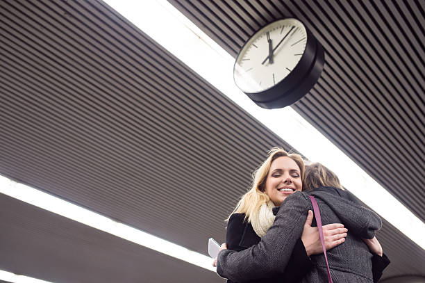 istock Senior couple standing at the underground platform, hugging 618536666
