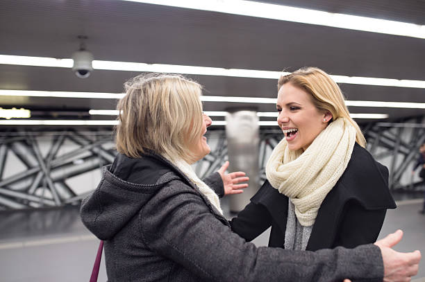 istock Senior couple standing at the underground platform, hugging 618536754