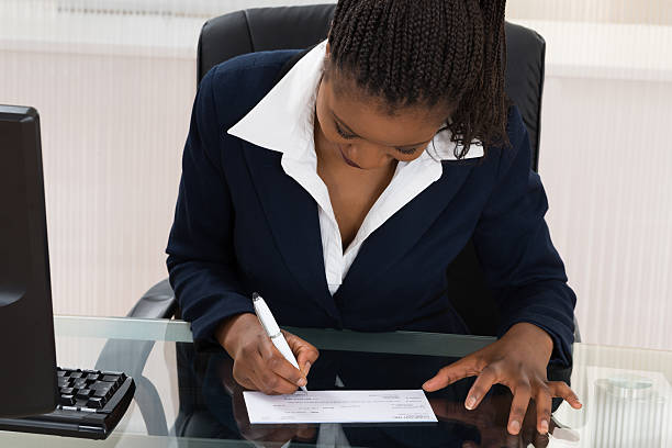 istock Businesswoman Signing Cheque 618537892