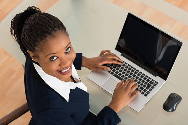 istock Smiling Young Businesswoman Using Laptop 618538176