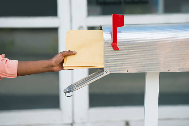 istock Person Putting Letters In Mailbox 618538496