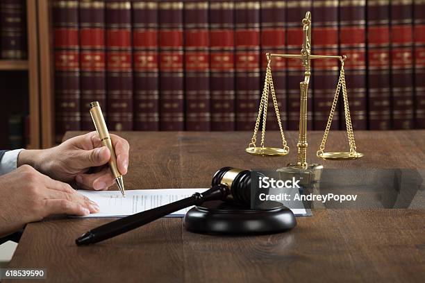 Judge Writing On Legal Documents At Desk Stock Photo - Download Image Now - Adult, Adults Only, Authority