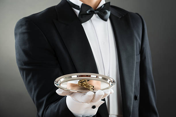 istock Midsection Of Waiter Holding Tray With Keys 618539812