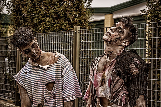 istock Two male zombies standing in empty city street 618540724