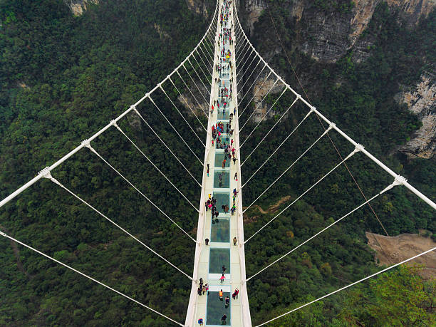Glass bridge of Zhangjiajie China Worlds highest and longest glass Bridge as of 2016 in Zhangjiajie, CHunan, China zhangjiajie stock pictures, royalty-free photos & images