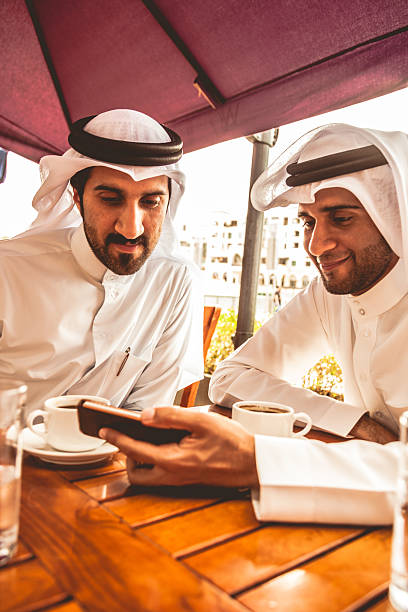 istock Talking about business at a cafe in Dubai 618543188