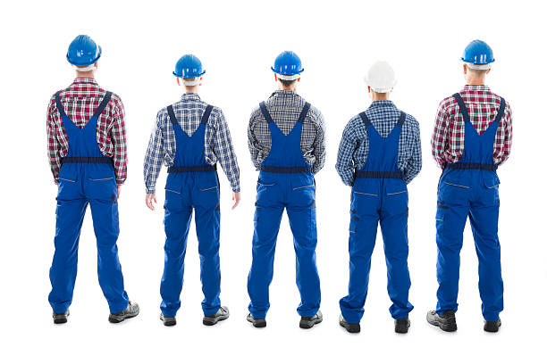 rear view of male carpenters standing in row - manual worker full length isolated on white standing imagens e fotografias de stock