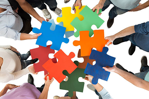 Creative Business People Holding Colorful Puzzle Pieces