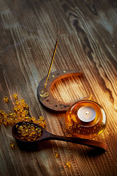 istock Candle in yellow glass candlestick with air bubbles inside, incense 618544268