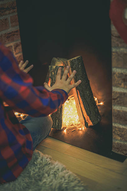 istock Happy little boy sitting on floor wrapping out christmas present 618544836