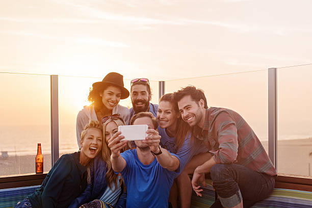 istock Group of friends taking selfies 618545276