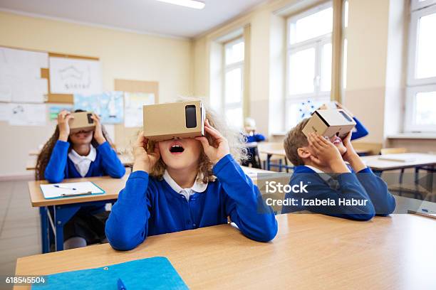 School Kids Using Virtual Reality Goggles Stock Photo - Download Image Now - School Uniform, Classroom, Digital Display