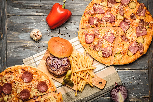 istock pizza and hamburger on wooden background 618546118