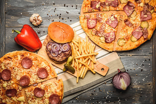 istock pizza and hamburger on wooden background 618546258