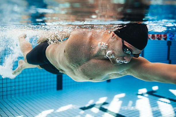 istock Professional male swimmer swimming in pool 618546410