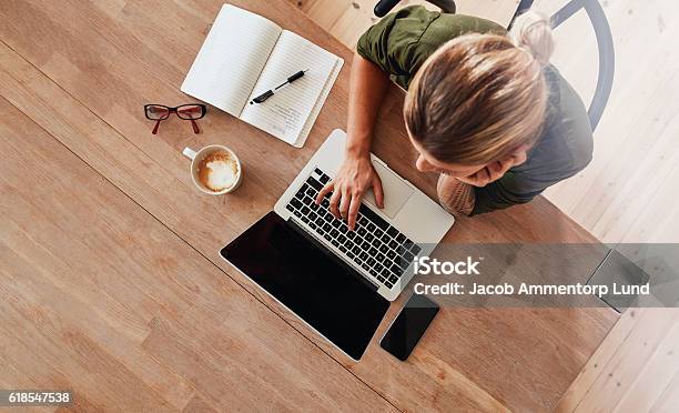 Woman Surfing Internet At Coffee Shop Stock Photo - Download Image Now - Desk, Laptop, Women