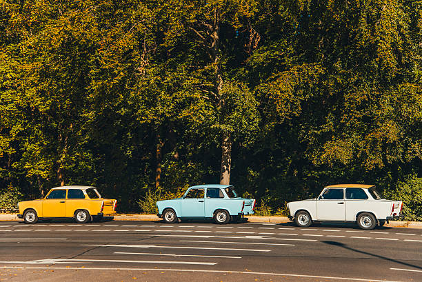 Bucharest, Romania, 24 October 2021: One vivid blue Trabant German vintage classic car parked in a street in the city center, in a sunny autumn day