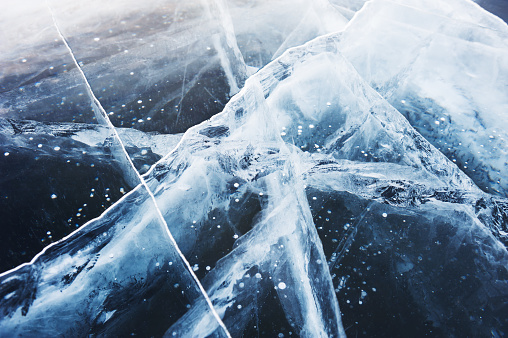 Beautiful blue ice on the winter lake. Macro image, selective focus.