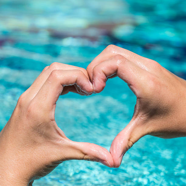 istock young man shows love sign 618547800