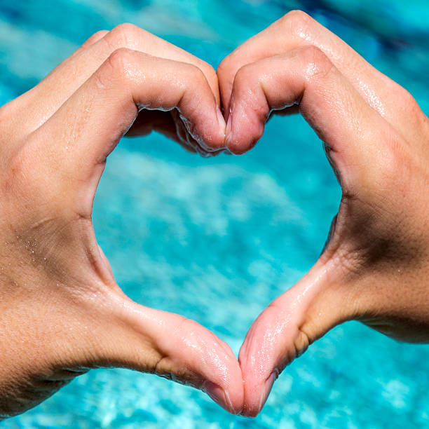 istock young man shows love sign 618547828