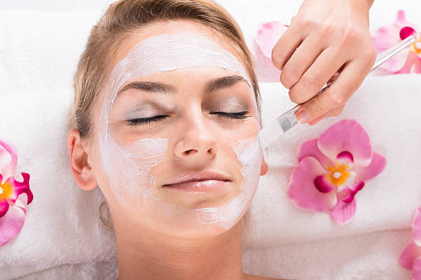 istock Beautician Applying Mask On Customer's Face At Salon 618552010